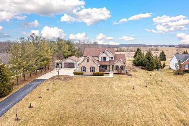 view of front of house with a front lawn, fence, and driveway