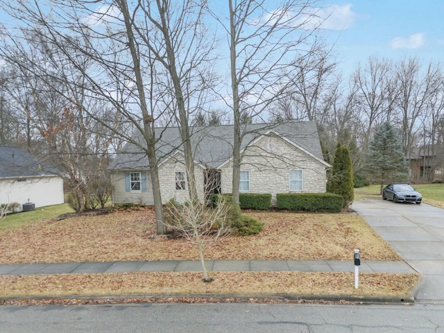 view of front of property featuring stone siding and driveway