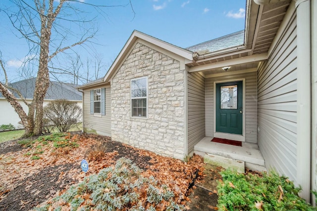 doorway to property featuring stone siding