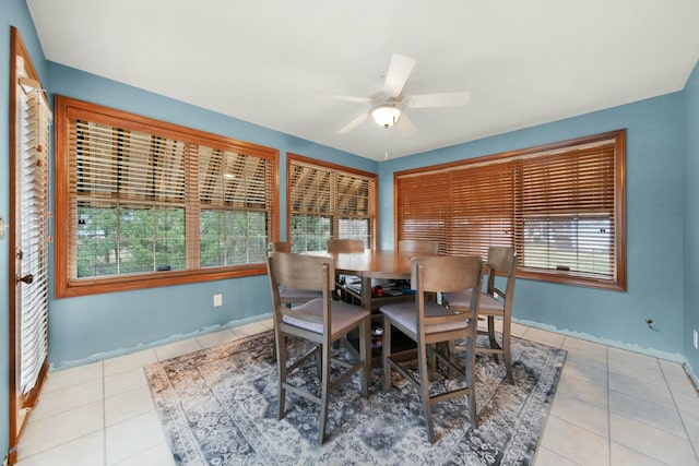 tiled dining room featuring ceiling fan