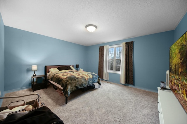 carpeted bedroom featuring baseboards and a textured ceiling