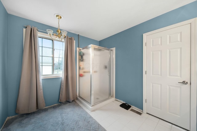 bathroom featuring baseboards, visible vents, tile patterned flooring, a shower stall, and a notable chandelier