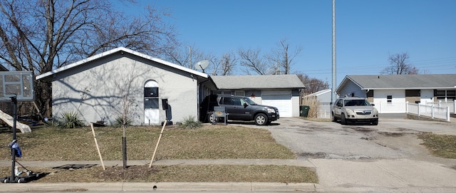 view of front facade with aphalt driveway and brick siding