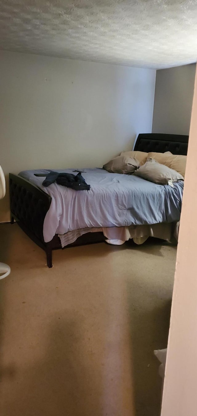 carpeted bedroom with a textured ceiling