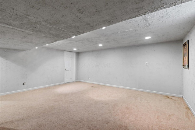 below grade area with recessed lighting, baseboards, and carpet flooring