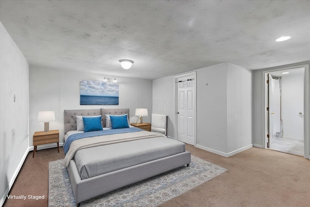 carpeted bedroom with baseboards and ensuite bathroom