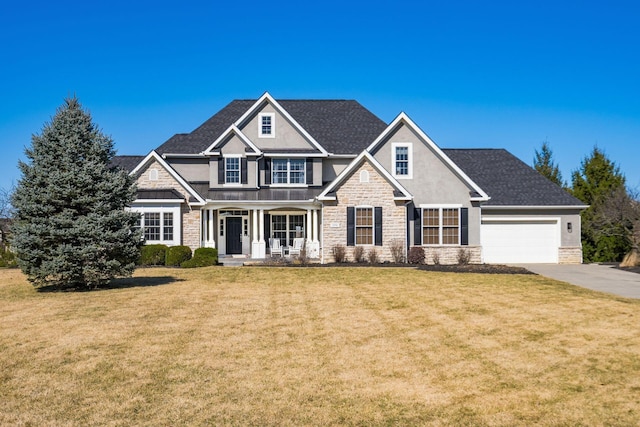 view of front of house featuring driveway, a standing seam roof, stucco siding, a front lawn, and stone siding