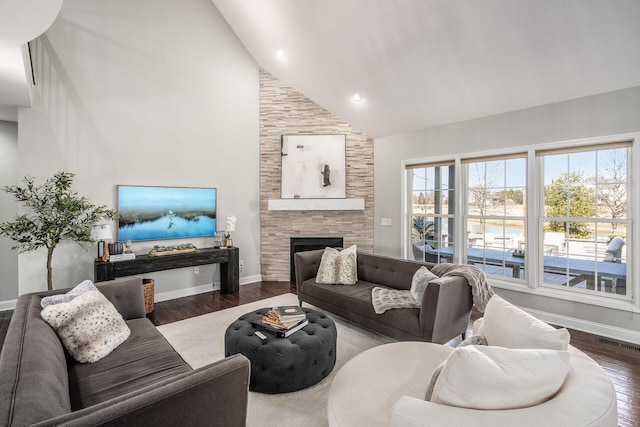 living room with plenty of natural light, high vaulted ceiling, visible vents, and wood finished floors