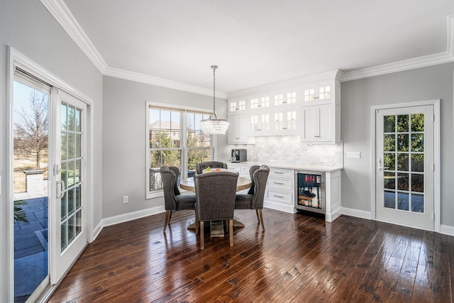 dining area featuring baseboards, wine cooler, dark wood-type flooring, and ornamental molding