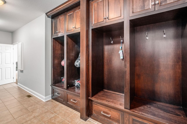 mudroom featuring light tile patterned floors and baseboards