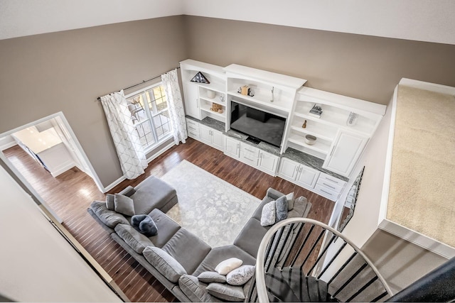 living area with high vaulted ceiling and dark wood-style floors