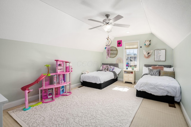 carpeted bedroom with lofted ceiling, a ceiling fan, and baseboards