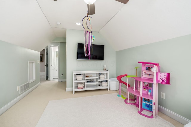 recreation room featuring lofted ceiling, baseboards, visible vents, and carpet floors