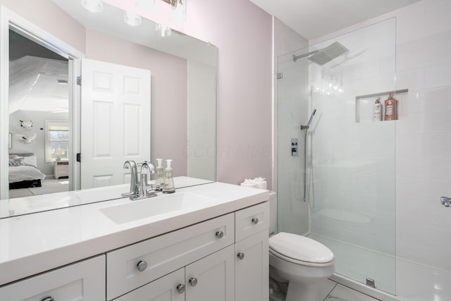 ensuite bathroom with vanity, toilet, ensuite bathroom, and tiled shower