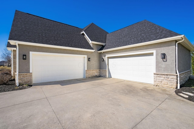 single story home with stone siding, stucco siding, an attached garage, and roof with shingles