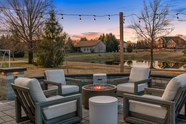 view of patio / terrace with a water view and an outdoor fire pit