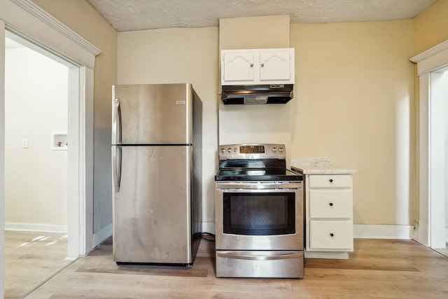 kitchen with under cabinet range hood, stainless steel appliances, light wood-style floors, and white cabinets