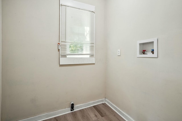 laundry area featuring washer hookup, laundry area, wood finished floors, and baseboards