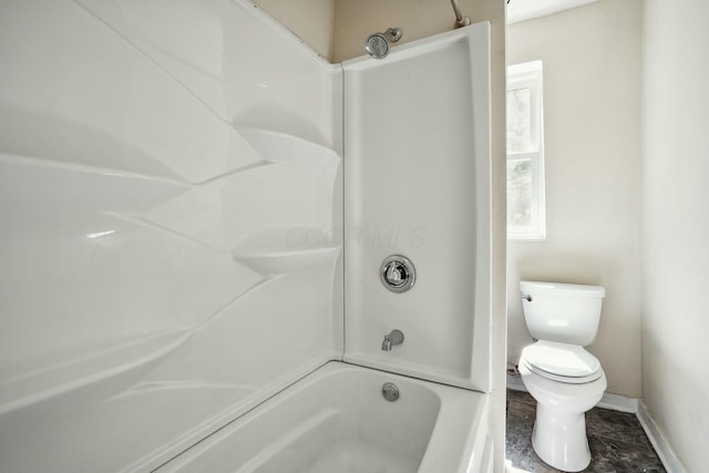 full bath with tub / shower combination, toilet, and baseboards