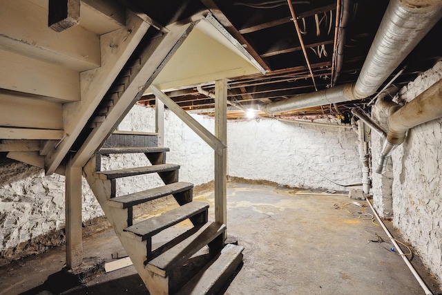 unfinished basement featuring stairs