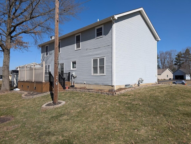 back of property with a lawn and a hot tub