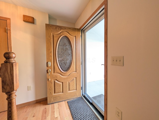 foyer with baseboards and light wood-type flooring