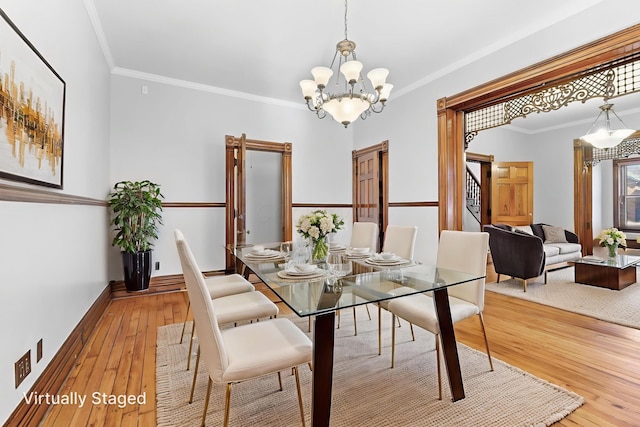 529 S 3rd St, Columbus, OH 43215 - dining room featuring stairs, crown molding, hardwood / wood-style floors, and a chandelier