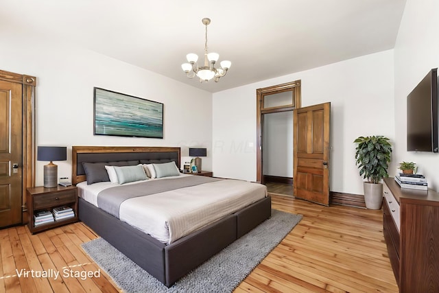 529 S 3rd St, Columbus, OH 43215 - bedroom with a chandelier and light wood-style floors