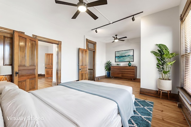 529 S 3rd St, Columbus, OH 43215 - bedroom with track lighting, light wood-style floors, and a ceiling fan