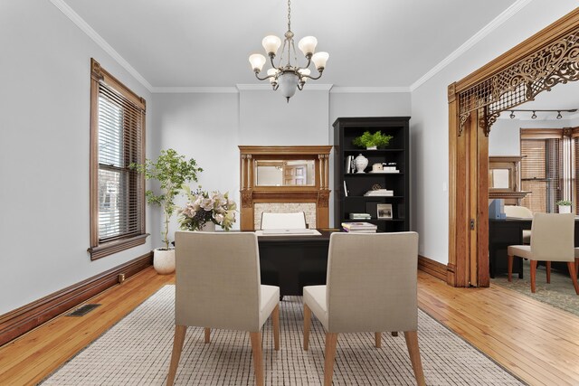 529 S 3rd St, Columbus, OH 43215 - dining space featuring hardwood / wood-style floors, a chandelier, and crown molding