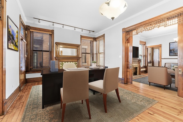 529 S 3rd St, Columbus, OH 43215 - dining space featuring hardwood / wood-style floors, a fireplace, rail lighting, and crown molding