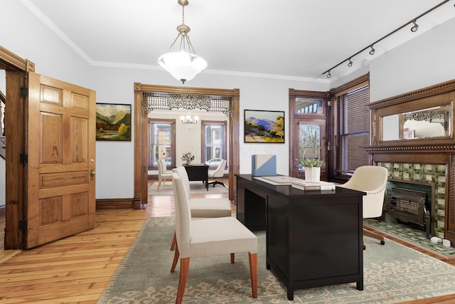 529 S 3rd St, Columbus, OH 43215 - dining room featuring a chandelier, light wood-style floors, a fireplace, ornamental molding, and track lighting