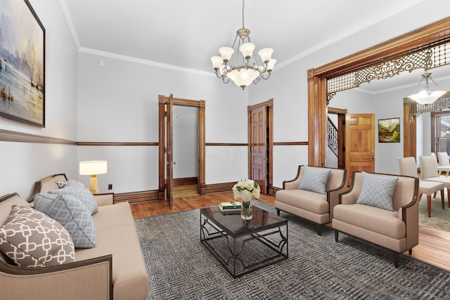 529 S 3rd St, Columbus, OH 43215 - living room with wood finished floors, a chandelier, crown molding, and stairs