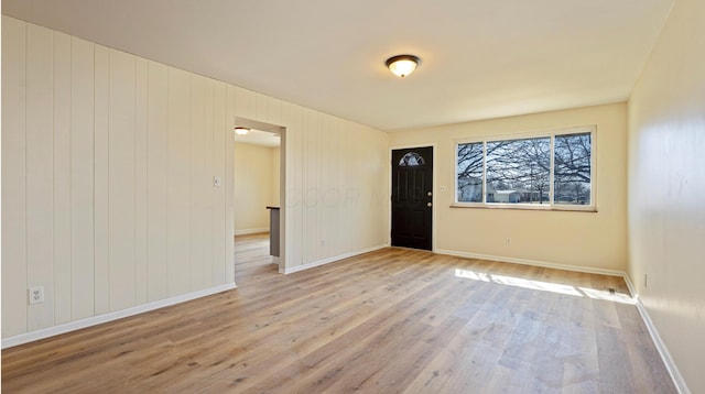 entrance foyer featuring baseboards and wood finished floors