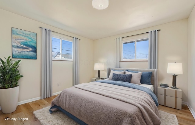 bedroom featuring light wood-type flooring and baseboards