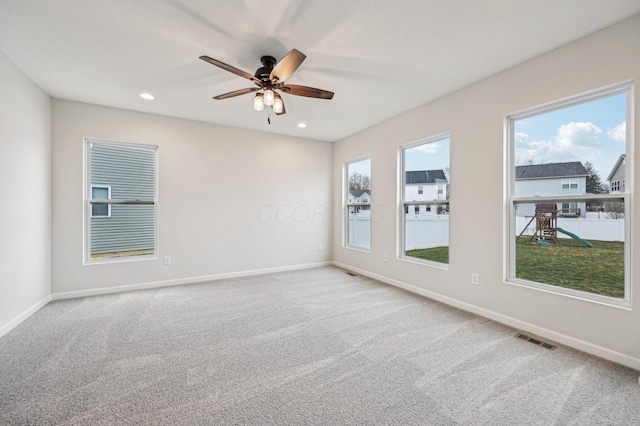 spare room with recessed lighting, visible vents, baseboards, and carpet