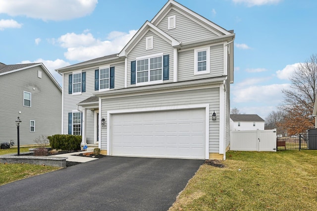 traditional home with fence, a front yard, a garage, driveway, and a gate