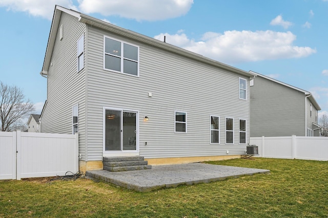 back of house featuring a fenced backyard, central AC unit, entry steps, and a yard