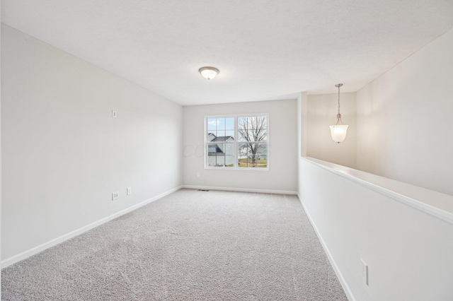 empty room with carpet flooring and baseboards