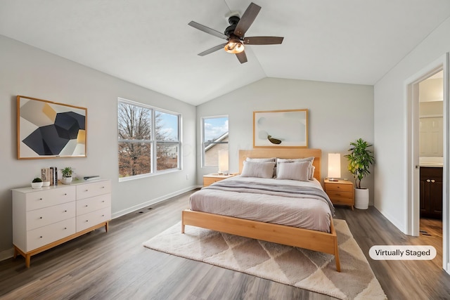 bedroom with ceiling fan, baseboards, wood finished floors, and vaulted ceiling