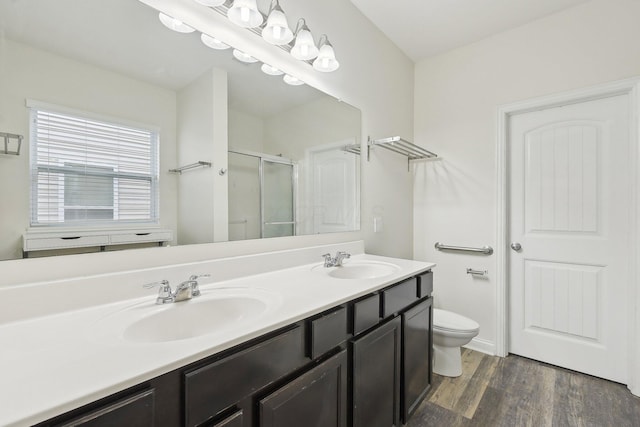 6741 Bigerton, Canal Winchester, OH 43110 - bathroom with a shower stall, wood finished floors, toilet, and double vanity