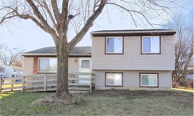 view of front of property featuring a front lawn, fence, and a wooden deck