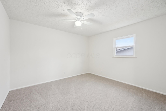 unfurnished room featuring baseboards, carpet, ceiling fan, and a textured ceiling