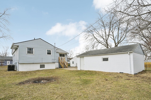 rear view of property featuring central AC unit, a lawn, an outdoor structure, and fence