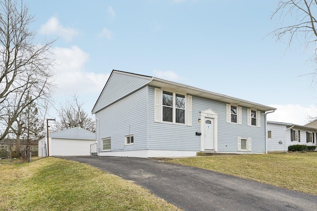 split foyer home featuring an outbuilding, a detached garage, and a front lawn