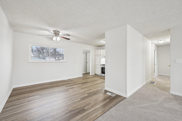 spare room with visible vents, ceiling fan, a textured ceiling, and baseboards