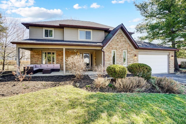 view of front of property featuring brick siding, an outdoor living space, aphalt driveway, an attached garage, and a patio