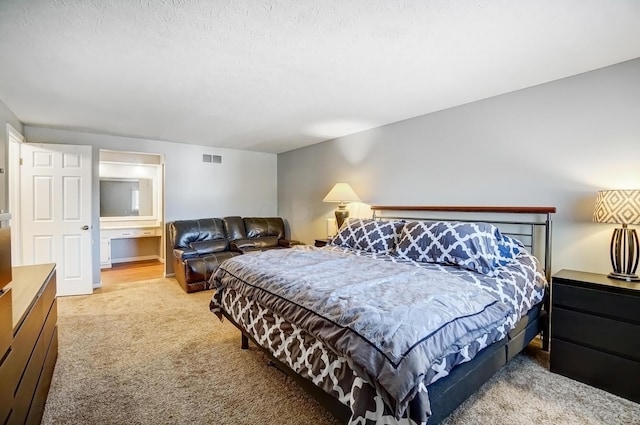 bedroom featuring light carpet and visible vents