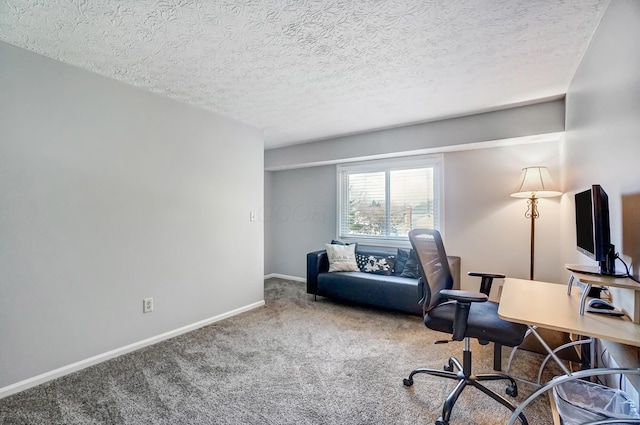 office with baseboards, carpet, and a textured ceiling