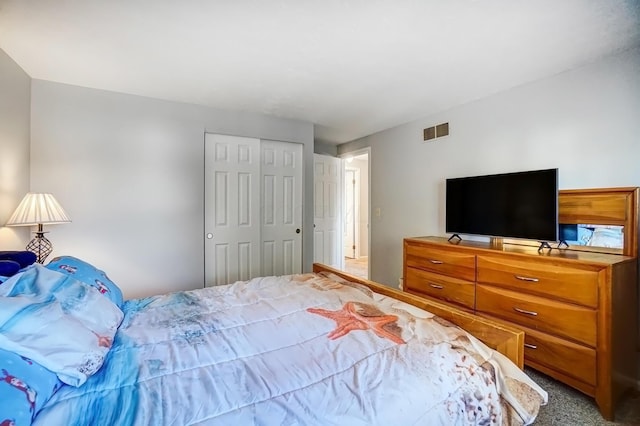 bedroom featuring carpet, visible vents, and a closet